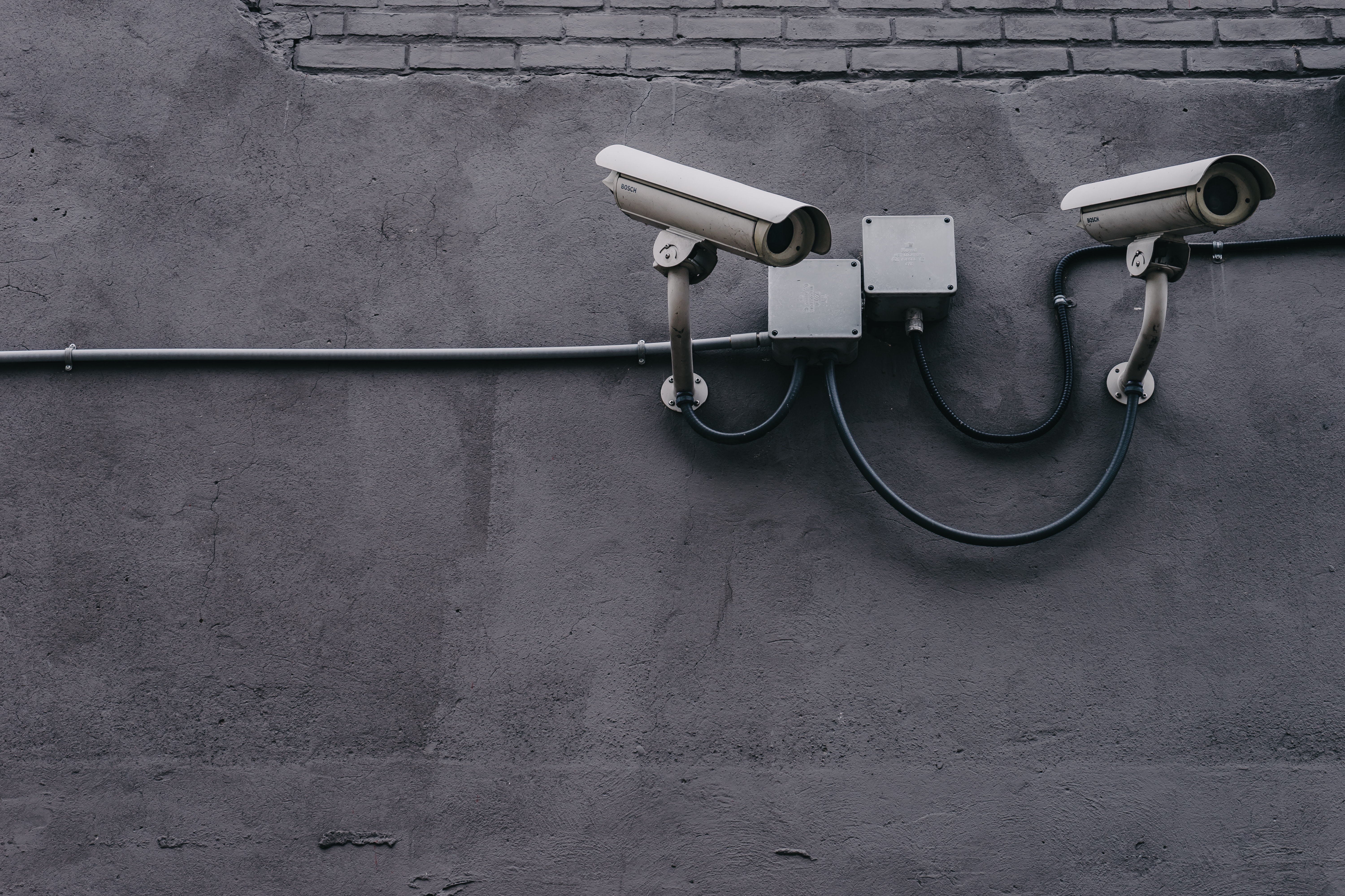 closed circuit cameras on a side of a building.